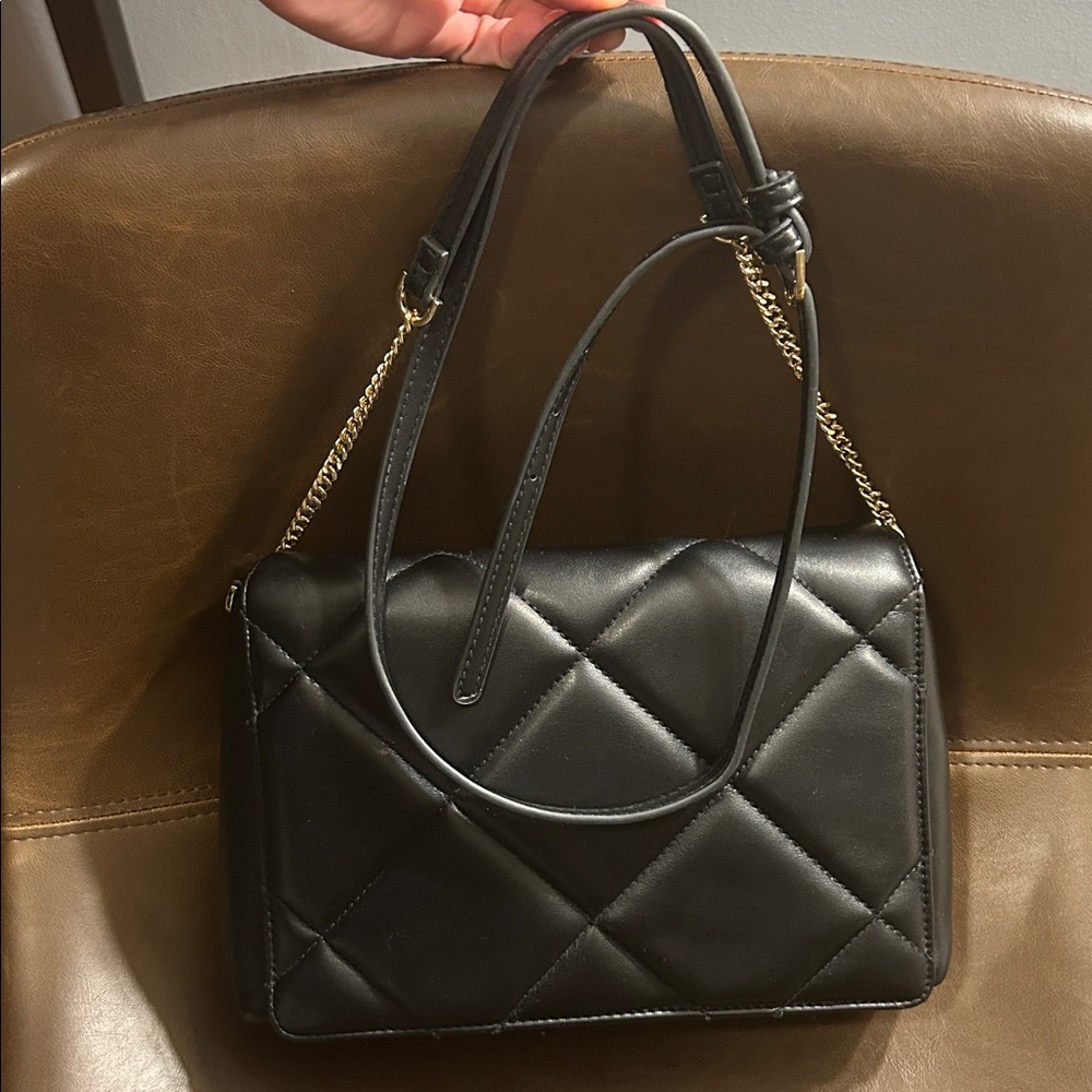 Crossbody black purse 7x10 with adjustable strap.